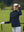 The model is wearing Women's Water-Resistant Stretch Fleece Lined Jacket navy on the golf course.