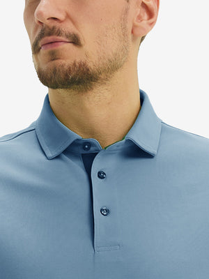 Front view from nose to chest of model wearing the misty blue ventilated pique performance polo, showcasing the upper fit