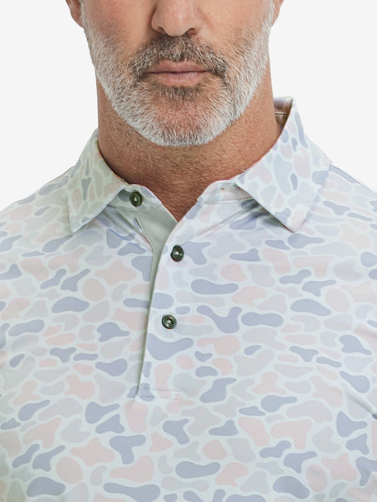 Close-up from nose to chest, showing collar and fabric pattern detail of the brown & gray camo polo shirt.
