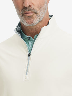 Close-up from nose to chest, showing collar detail and zipper of the cream golf vest.
