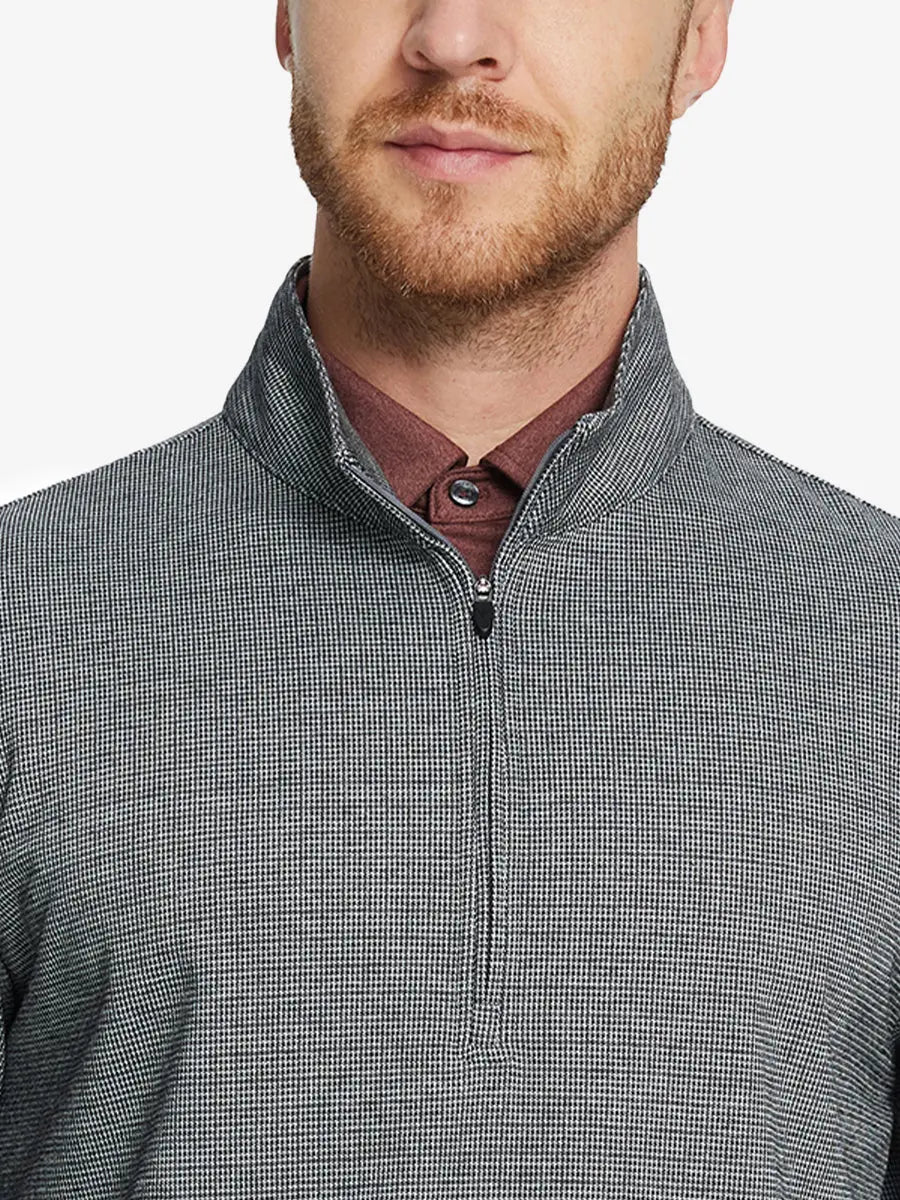 Front half-body view from nose down of model wearing BLACK HOUNDSTOOTH Premium Jacquard Quarter Zip Pullover.								
