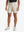 LIGHT KHAKI 4-way Stretch Performance Solid Shorts, golfer front lower body with club, 7 Inch view