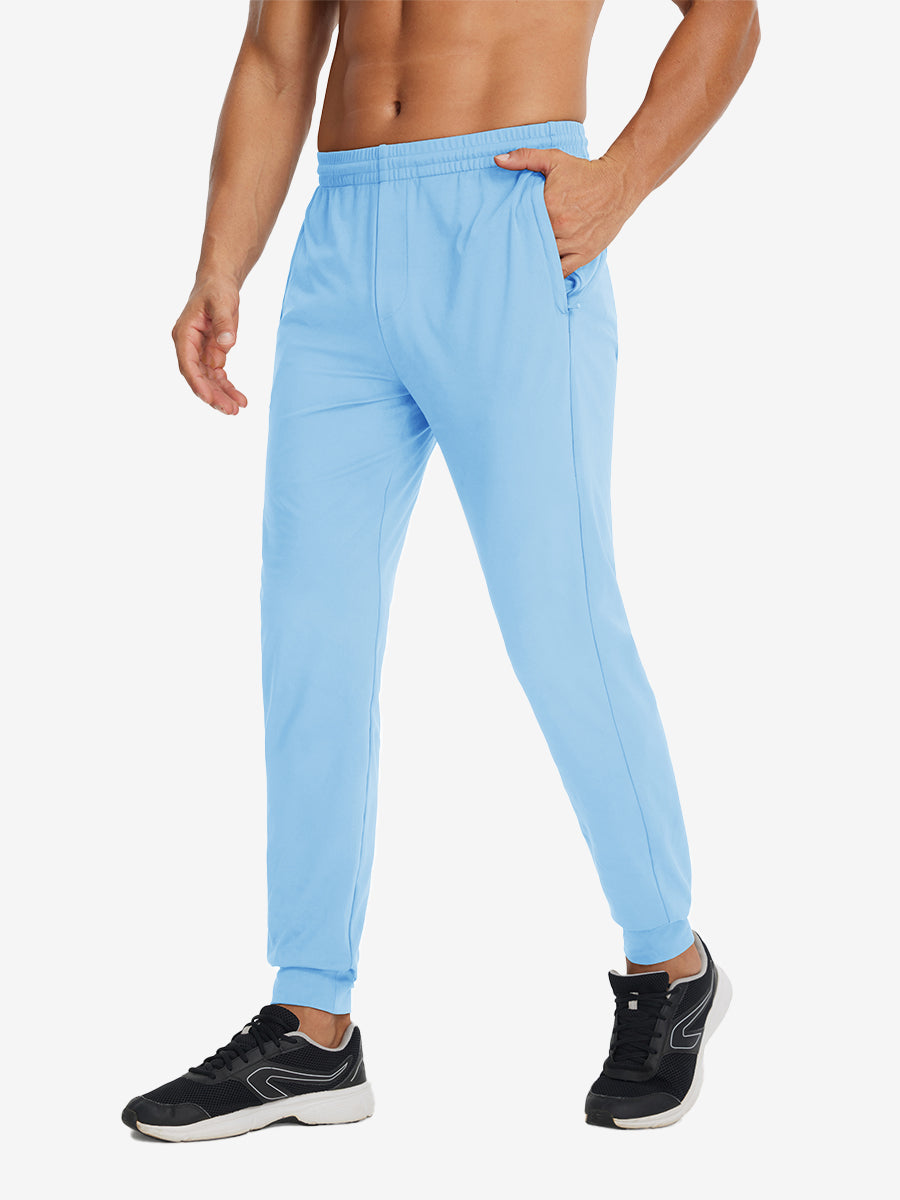 Side view of model with hand in pocket wearing lightweight traning track pants in light blue.