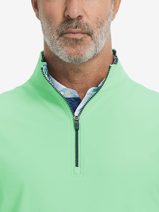 Close-up from nose to chest, showing collar detail and zipper of the dark grey golf vest.