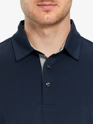 Model showcasing the navy long sleeve pique polo, emphasizing its modern style and comfort.