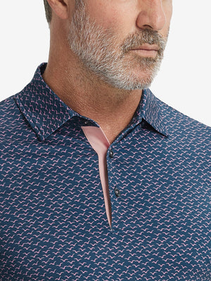 Close-up from nose to chest, showing collar and fabric pattern detail of the navy pink seagull polo shirt.