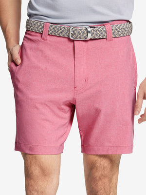 Front view of youth wearing pink Heather Performance Golf Shorts, showing fit and style