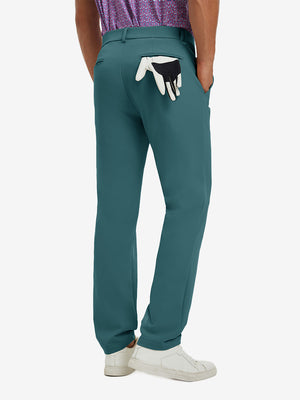 Back view of model wearing water-resistant golf stretch nylon pants, tailored stretch fit in dark teal.