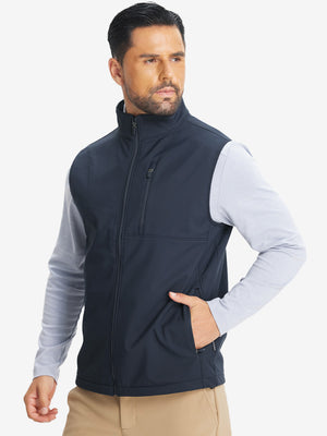 Model front half-body shot with one hand in pocket wearing sleeveless softshell fleece outdoor vests with 6 pockets in navy
