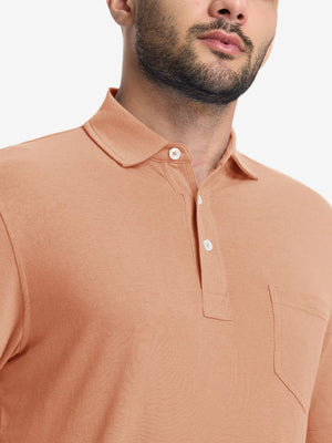 Front view from nose to chest of model wearing the orange adobe heather comfy cotton blend polo shirt with pocket, showcasing the upper fit