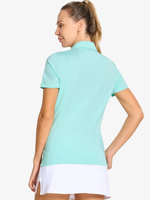 Back-side half-body shot of model in BLUE LIGHT Women's Performance Solid Polo, looking over shoulder