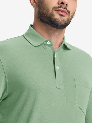 Front view from nose to chest of model wearing the spa green heather comfy cotton blend polo shirt with pocket, showcasing the upper fit