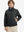 Boys windproof puffer jacket with pockets in black, model front upper-body with one hand in pocket.