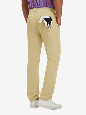 Back view of model wearing water-resistant golf stretch nylon pants, tailored stretch fit in khaki.