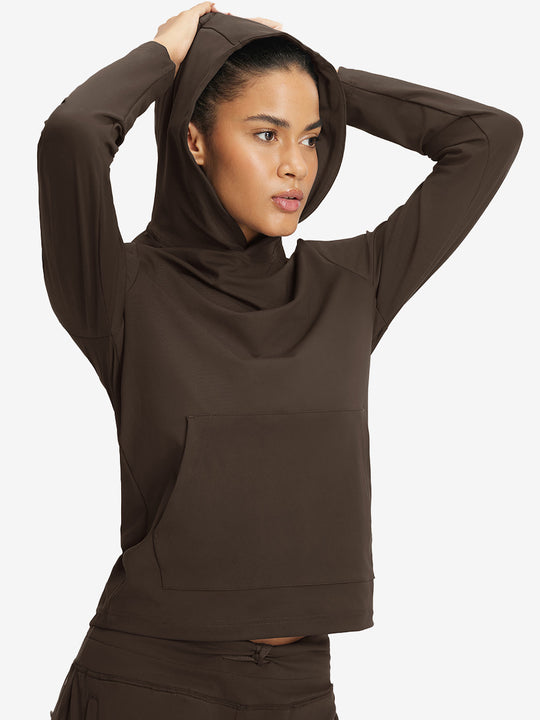 Model holding hoodie cap with both hands, wearing women's lightweight hoodies pullover in coffee brown.