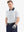 Half-body front view of model with hand in pocket wearing WHITE NAV CLUE Performance Quick Dry Print Golf Polo.