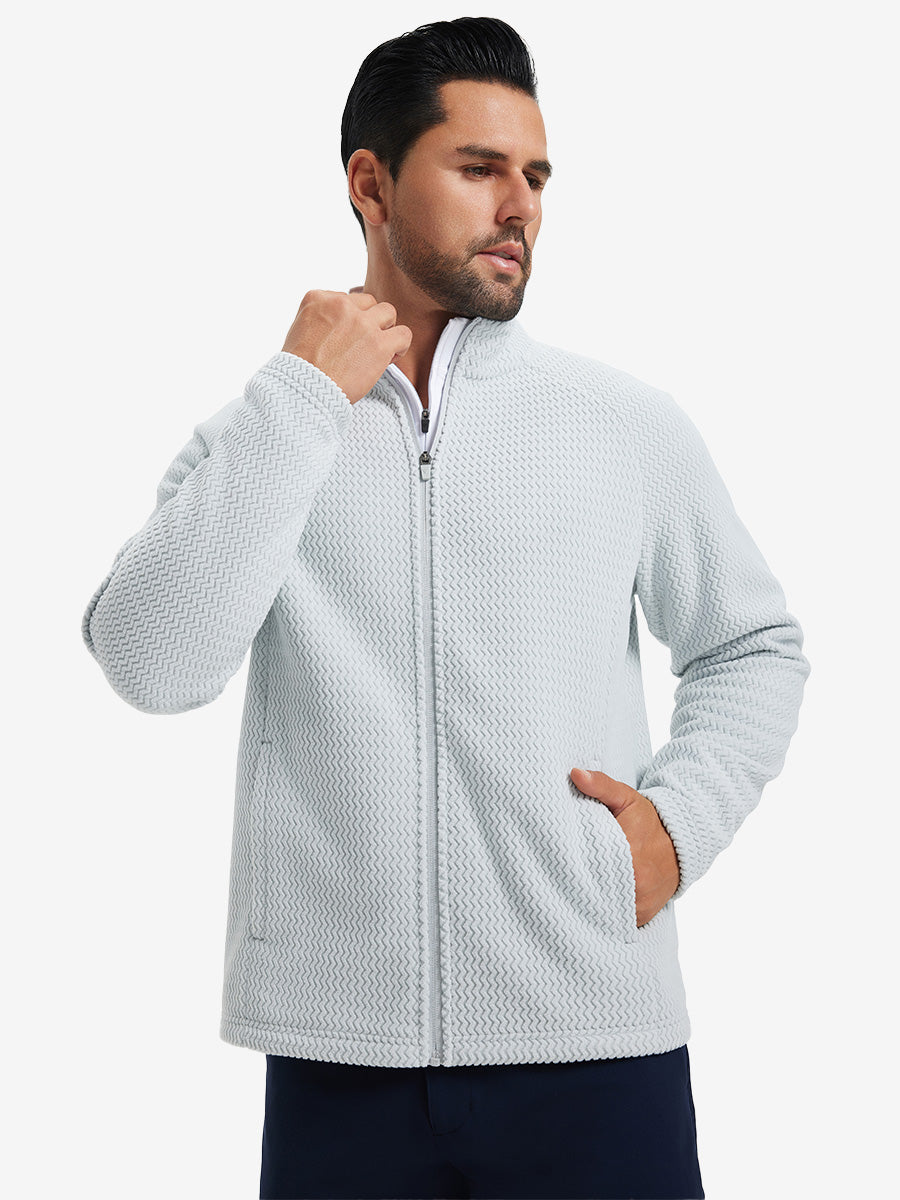 Model with both hands in pockets, wearing soft winter fleece jackets in light grey, warm and relaxed.