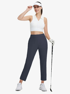Full-body front view wearing golf hat and holding club in NAVY Women's 7/8 Ankle Golf Track Pants.