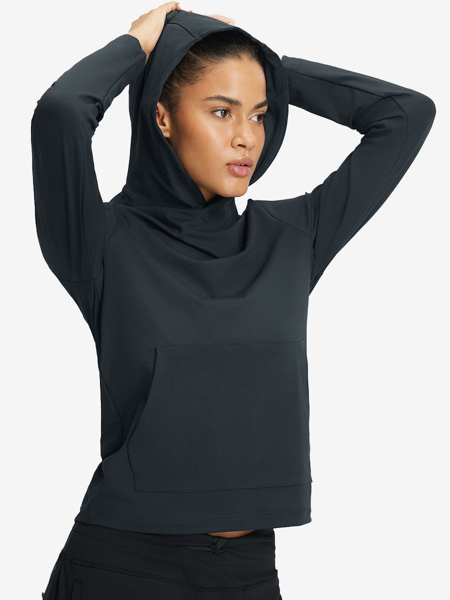Model holding hoodie cap with both hands, wearing women's lightweight hoodies pullover in dark grey.