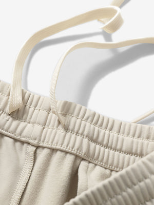 Close-up of the waistband with drawstring detail of light khaki fleece stretch water resistant boys joggers.