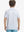 Back half-body view of boy wearing WHITE GOLF Performance Print Boys Golf Polo outdoors