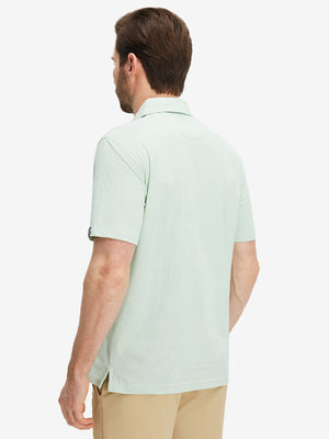 Back half-body view of a model wearing the emerald feather weight jacquard polo shirts, highlighting the rear fit