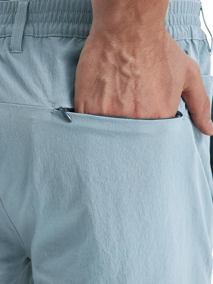 Back view of Performance Water Resistant Pants in POWDER BLUE，model’s hand casually in back pocket.