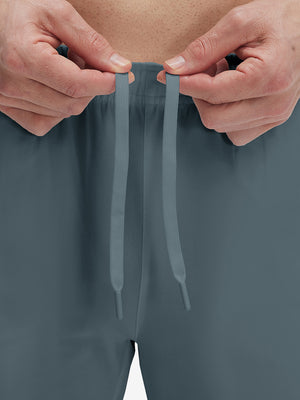 Close-up of elastic waistband on misty blue superion softness mesh joggers with zipper pockets