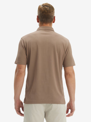 Back half-body view of model wearing the light brown ventilated pique performance polo, highlighting the rear silhouette