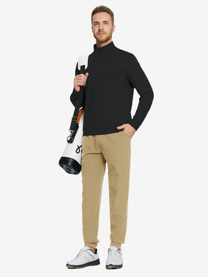 Model carrying a tennis bag, wearing black quarter zip melange pullover in full-body view.