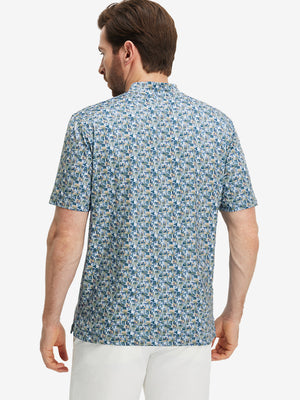 Back half-body of model in blue abstract stretch printed collarless henley golf shirts