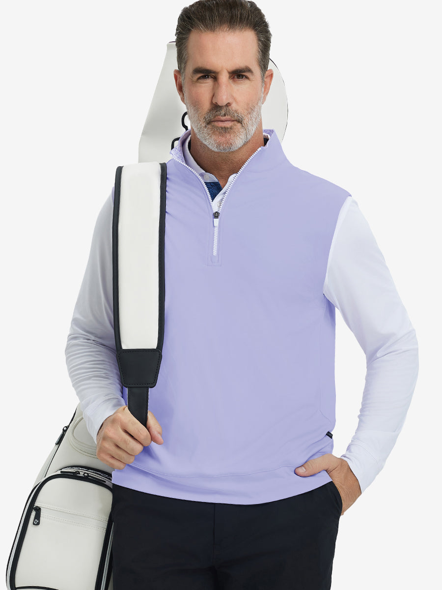 Model carrying golf bag, styled in lavender print collar quarter zip golf vest, relaxed sporty fit.