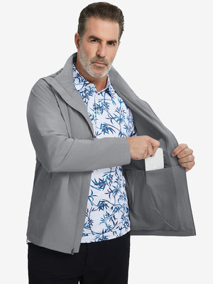 Model placing an iPhone into the inner pocket of the lightweight water-repellent softshell hooded jacket in neutral grey.