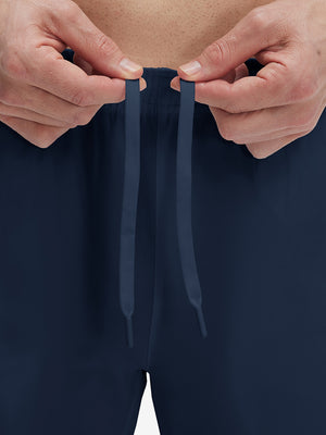 Close-up of elastic waistband on navy superion softness mesh joggers with zipper pockets