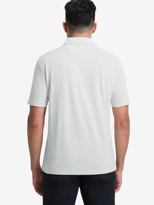 Back half-body view of model wearing the blue presence heather comfy cotton blend polo shirt with pocket, highlighting the rear silhouette