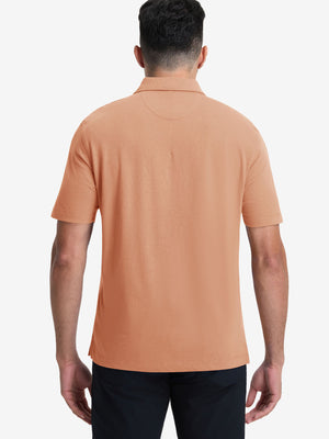 Back half-body view of model wearing the orange adobe heather comfy cotton blend polo shirt with pocket, highlighting the rear silhouette