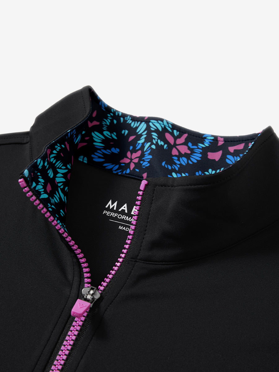 Zipper and inner pattern detail of the print collar quarter zip golf vest in black, highlighting design.