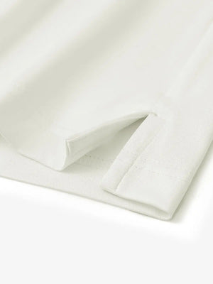 Close-up detail of hem slit on Everyday Solid Jersey Polo in CREAM, showing quality stitching.
