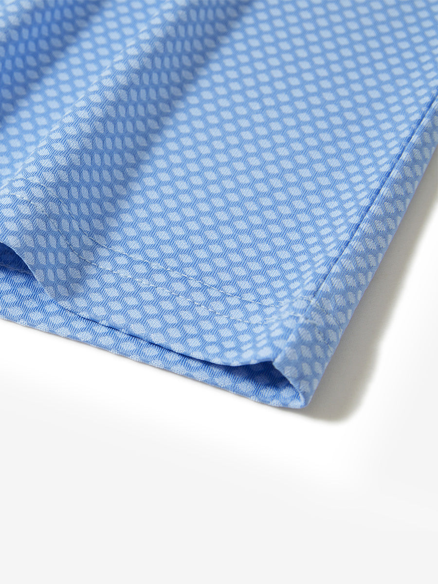 Hem detail of jacquard quarter zip pullover in light blue, focusing on stitching and side vent finish.