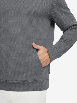 Close-up of model with both hands in pockets wearing warm fleece golf hoodies pullover grey.