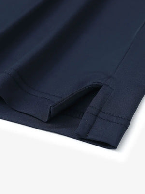 Close-up detail of hem slit on Everyday Solid Jersey Polo in NAVY, featuring quality stitching.