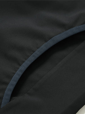 Side pocket detail of the mock neck quarter button golf pullover in black, practical design feature.