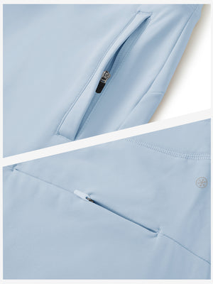 Detailed view of the front side pocket on women's stretch fleece lined water resistant joggers in light grayish blue, showing stitching and design.