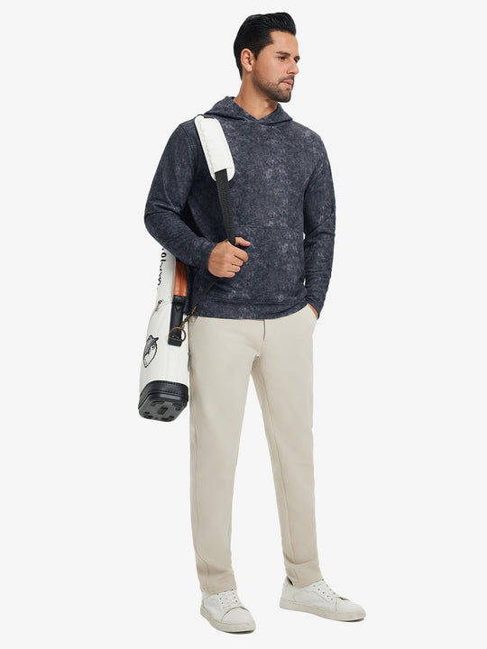 Model carrying a golf bag while wearing exclusive print kangaroo hoodies in navy, full-body shot.