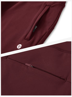 Detailed view of the front side pocket on women's stretch fleece lined water resistant joggers in wine, showing stitching and design.