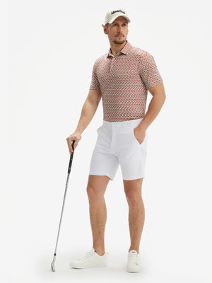 Full-body shot of model holding a golf club in brick white flower performance quick dry print golf polos