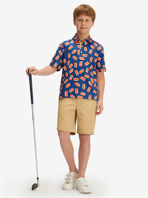 Full front: boy in hot dog performance print boys golf polo holding golf club.