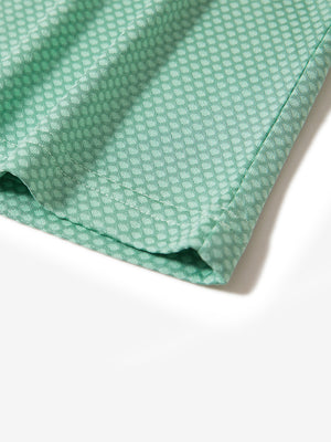 Hem detail of jacquard quarter zip pullover in light green, focusing on stitching and side vent finish.