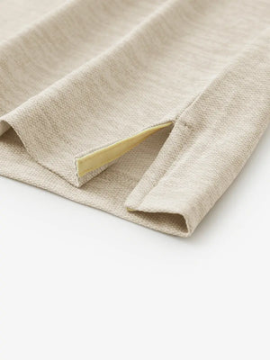 Hem slit detail of LIGHT KHAKI HEATHER Premium Stretch Heather Polo highlighting stitching and finish.