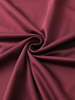 Close-up of burgundy chest print polo shirt fabric showing smooth texture and crisp graphic application area.